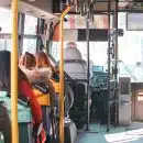 woman in orange jacket sitting on bus seat